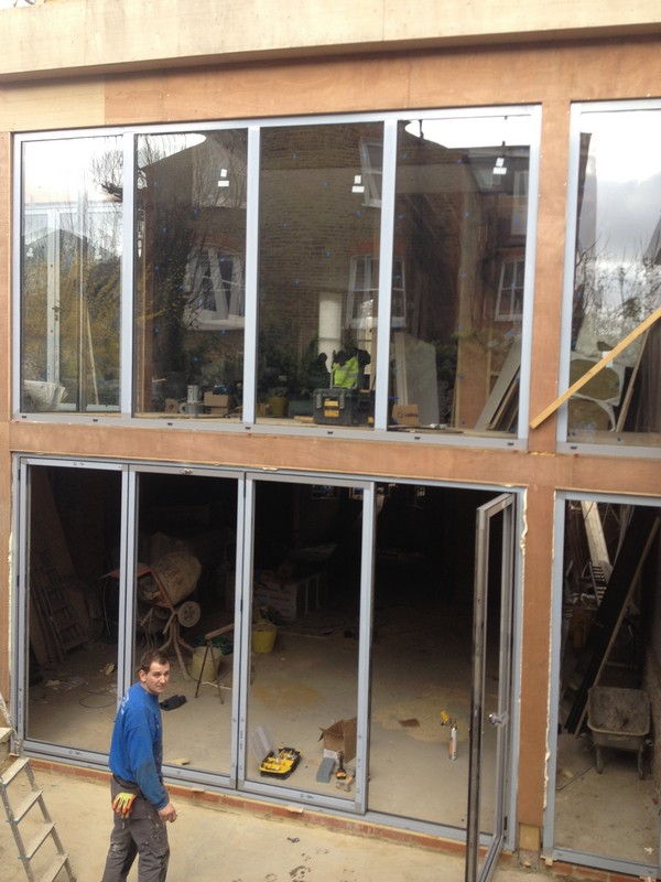 Aluminium bi-fold doors with two-storey glazing in Southall