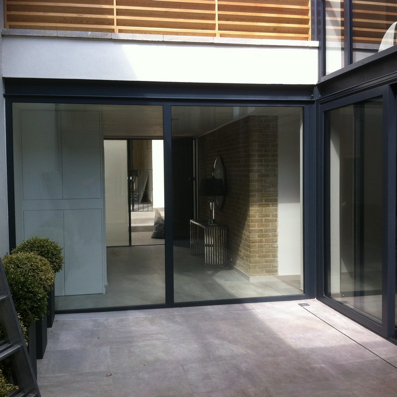 Floor-to-ceiling sliding doors opening to courtyard in Southall