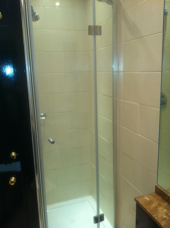 Frameless glass shower enclosure with chrome fittings in Southall