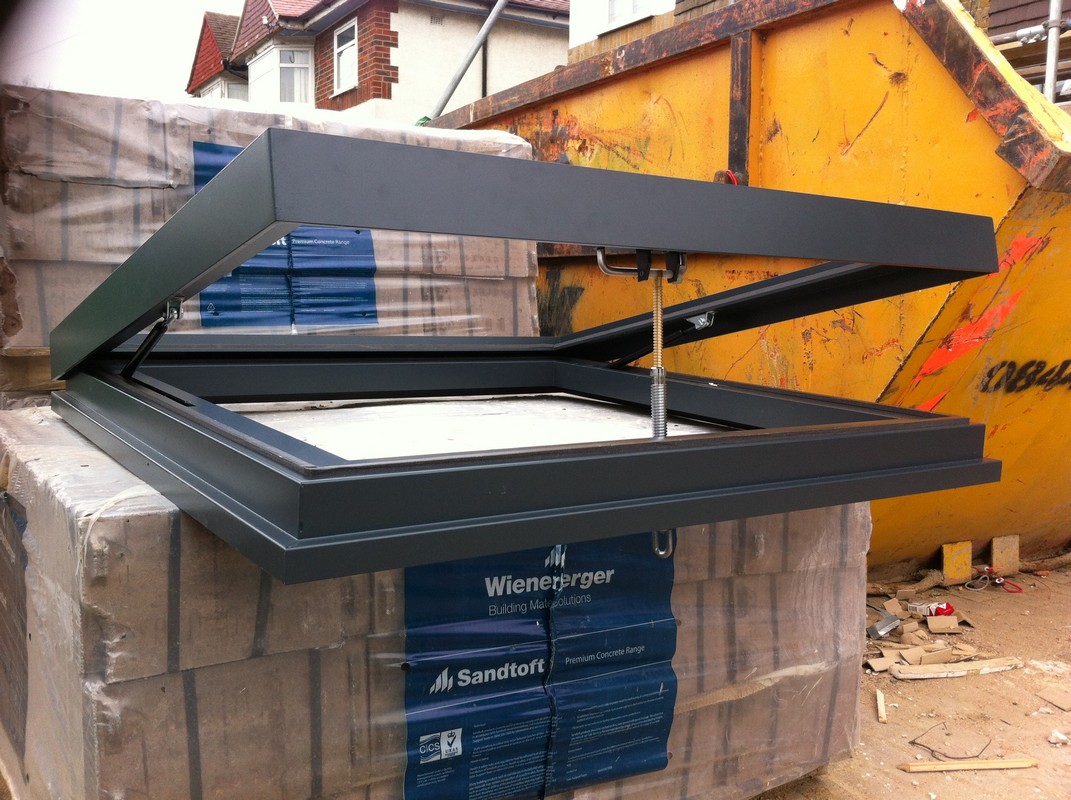 Opening flat roof skylight in anthracite grey installed in Southall