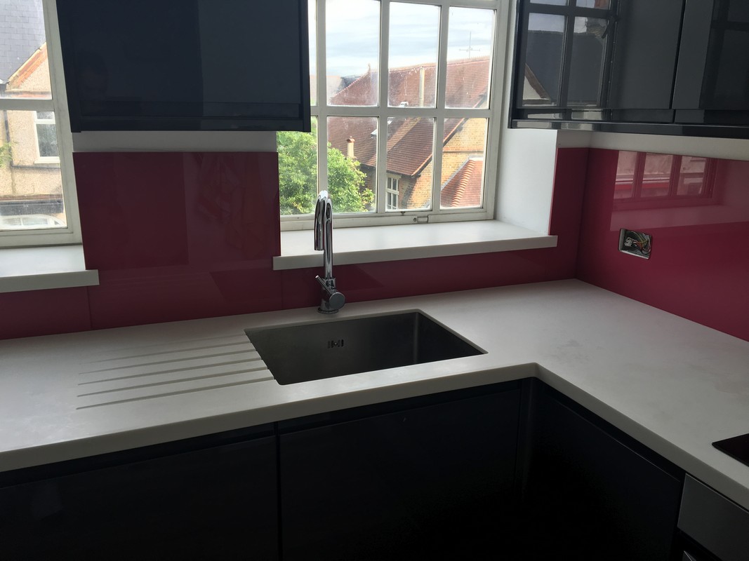 Deep plum coloured glass splashback in modern Southall kitchen