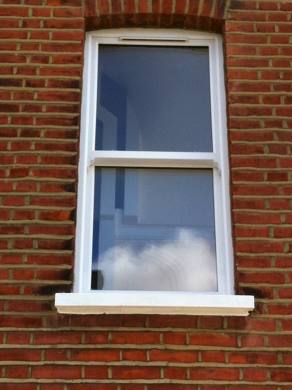 uPVC sash window on Victorian red brick house in Southall